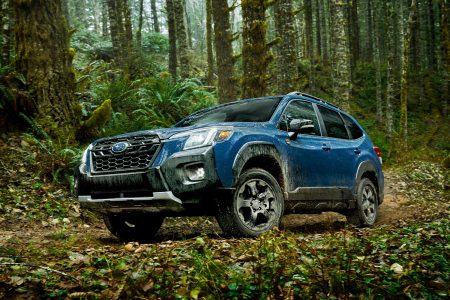 The 2022 Subaru Forester Wilderness in blue driving off-road