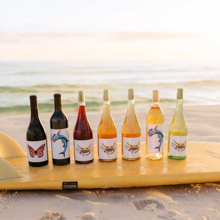 Tarpon Cellars lineup of wine on a surfboard